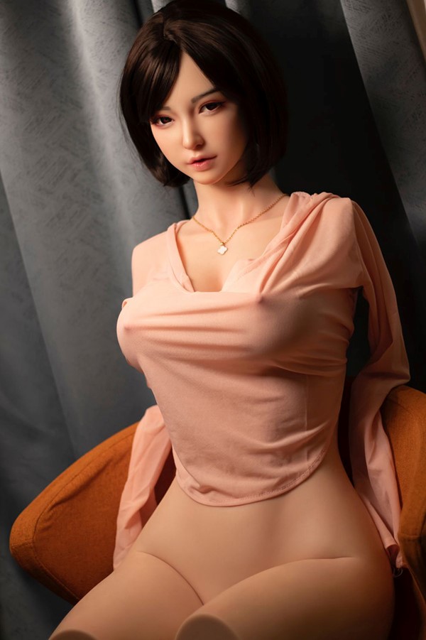 Sex Doll with big tits, laying on a seat ready to be pounded the fuck out of.