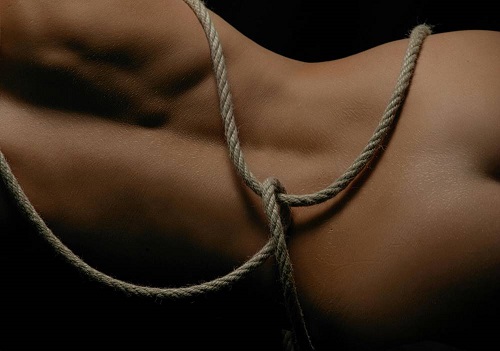 Sexy babe exploring BDSM fantasies in ropes, as she awaits a kinky BDSM massage from the hot masseuse.