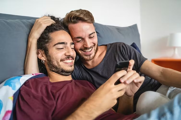 A cute couple using AI on their phone and exploring it's best use and how they can set their personalization and other stuff.